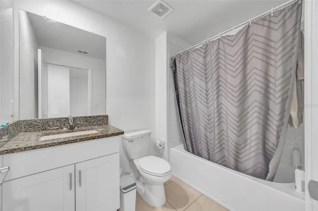 a spacious bedroom with a bed and a ceiling fan