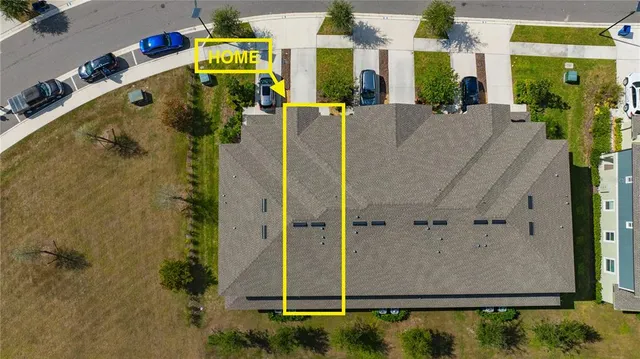 an aerial view of house with a yard