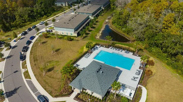 an aerial view of a house with a yard
