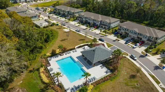 a view of swimming pool with a garden and outdoor seating