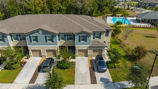 an aerial view of a house with a garden and lake view