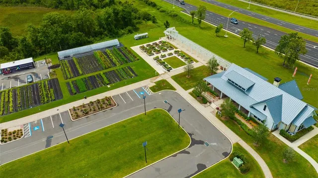 an aerial view of a house with a big yard