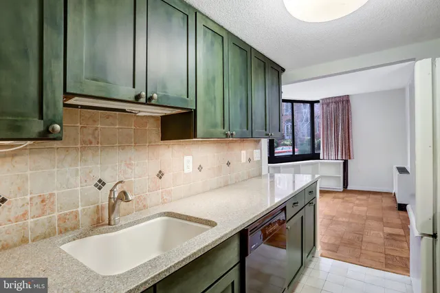 a kitchen with stainless steel appliances a sink and a microwave