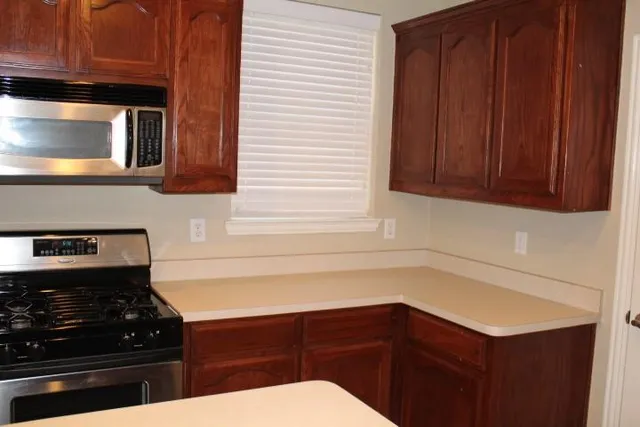 a kitchen with a sink and a stove top oven