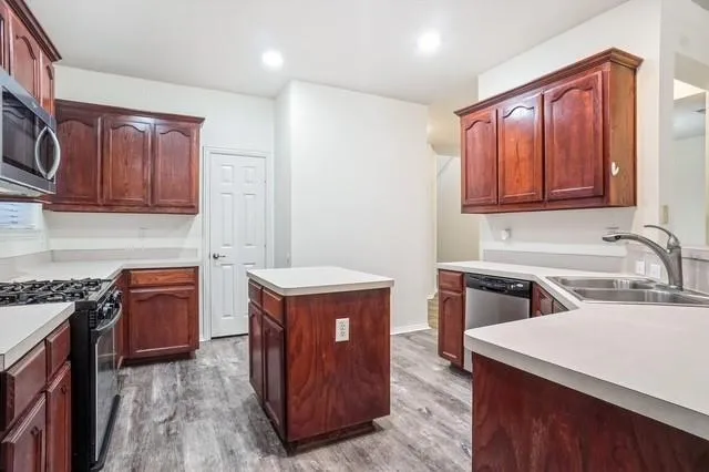 a kitchen with a sink cabinets and a window