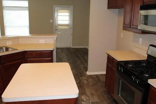 a stove top oven sitting inside of a kitchen