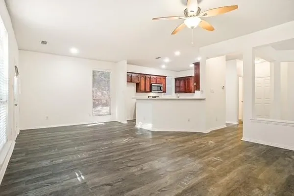 a view of empty room with fireplace and fan