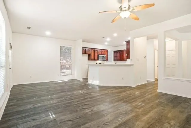a view of empty room with fireplace and fan