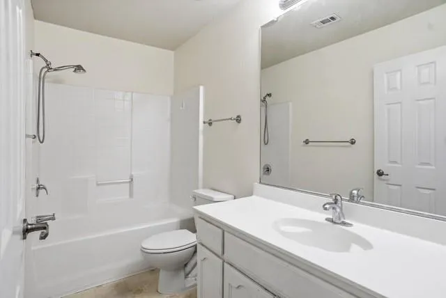 a view of an empty room with a ceiling fan