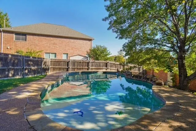 a view of a backyard with swimming pool