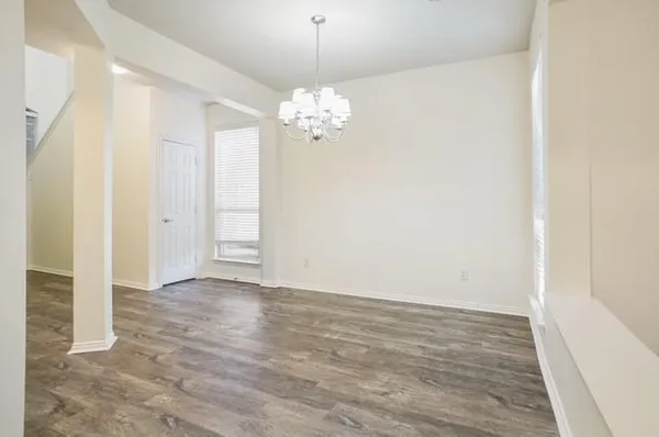 a view of a hallway with wooden floor and closet area
