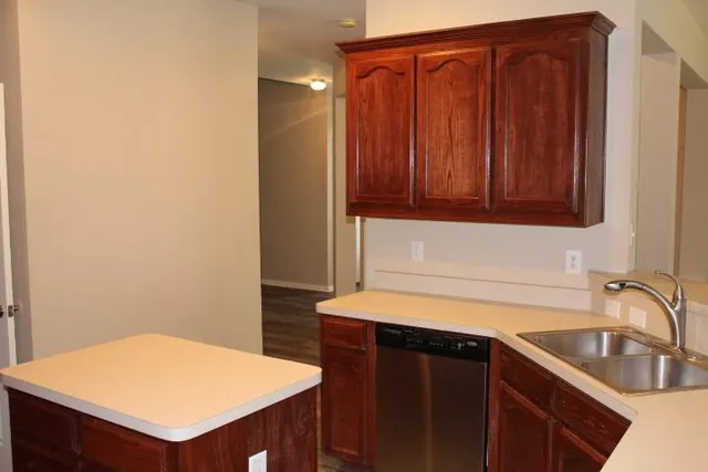 a kitchen with wooden cabinets and a stove top oven