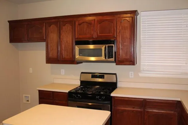 a stove top oven sitting inside of a kitchen
