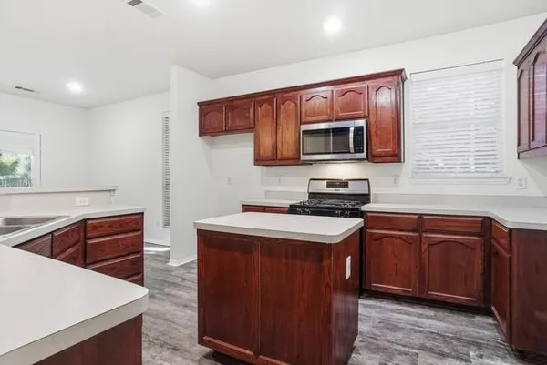 a kitchen with a sink a counter top space and cabinets