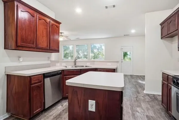 a kitchen with stainless steel appliances granite countertop a sink stove and microwave
