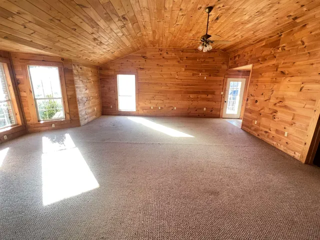 a view of a livingroom with an empty space and a window