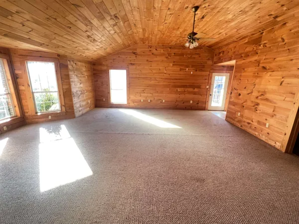 a view of a livingroom with an empty space and a window