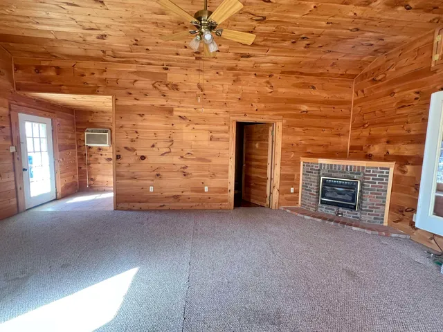 a view of empty room with fireplace
