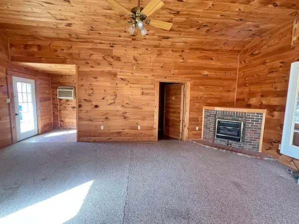 a view of empty room with fireplace