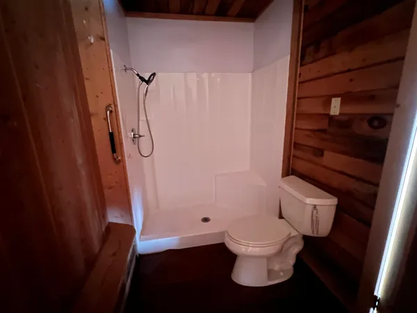 a bathroom with a toilet and a shower