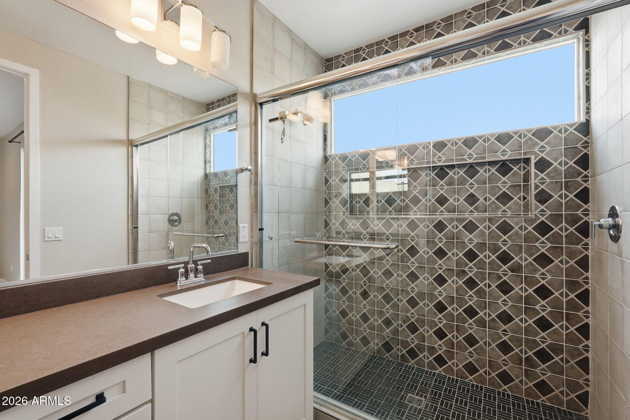 901 South Smith Road, Unit 1038 Tempe, AZ 85281 - Photo 15 of 29 a bathroom with a sink a vanity and a shower