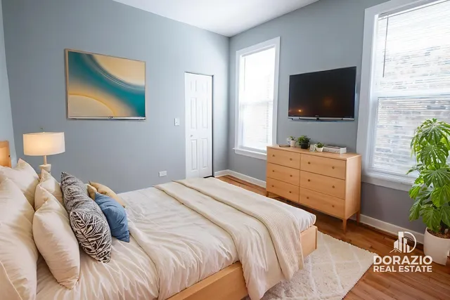 a bedroom with a bed and a flat screen tv
