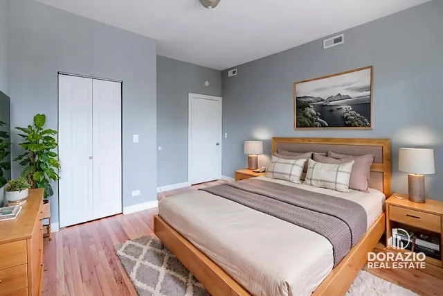 a bedroom with a bed and a potted plant