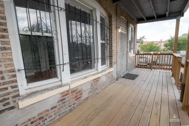 a view of outdoor space with wooden floor and windows