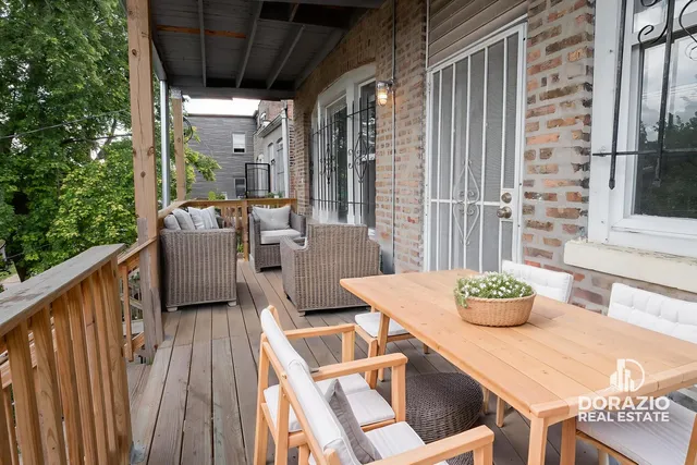 a outdoor dining space with furniture and wooden floor