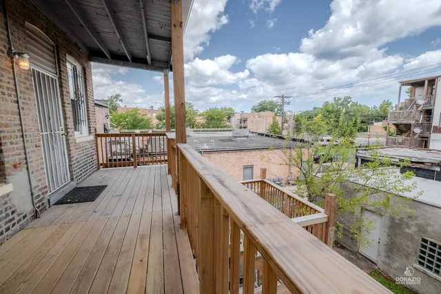 a view of balcony with wooden floor and fence