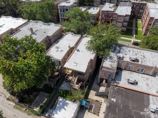 an aerial view of a house with a yard and outdoor seating