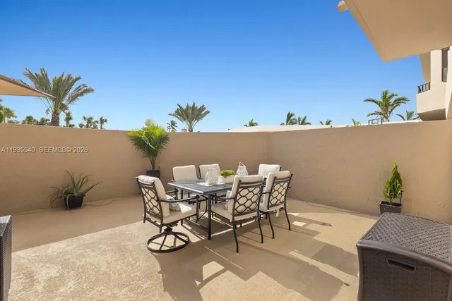 a view of a dining table and chairs in patio