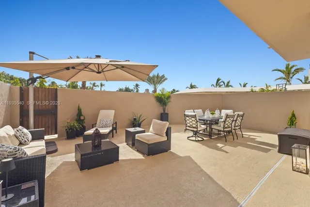 a view of a patio with couches and table and chairs