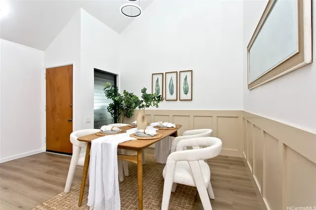 a dining room with furniture and wooden floor