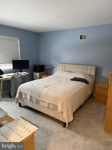 a bedroom with a bed and lamp
