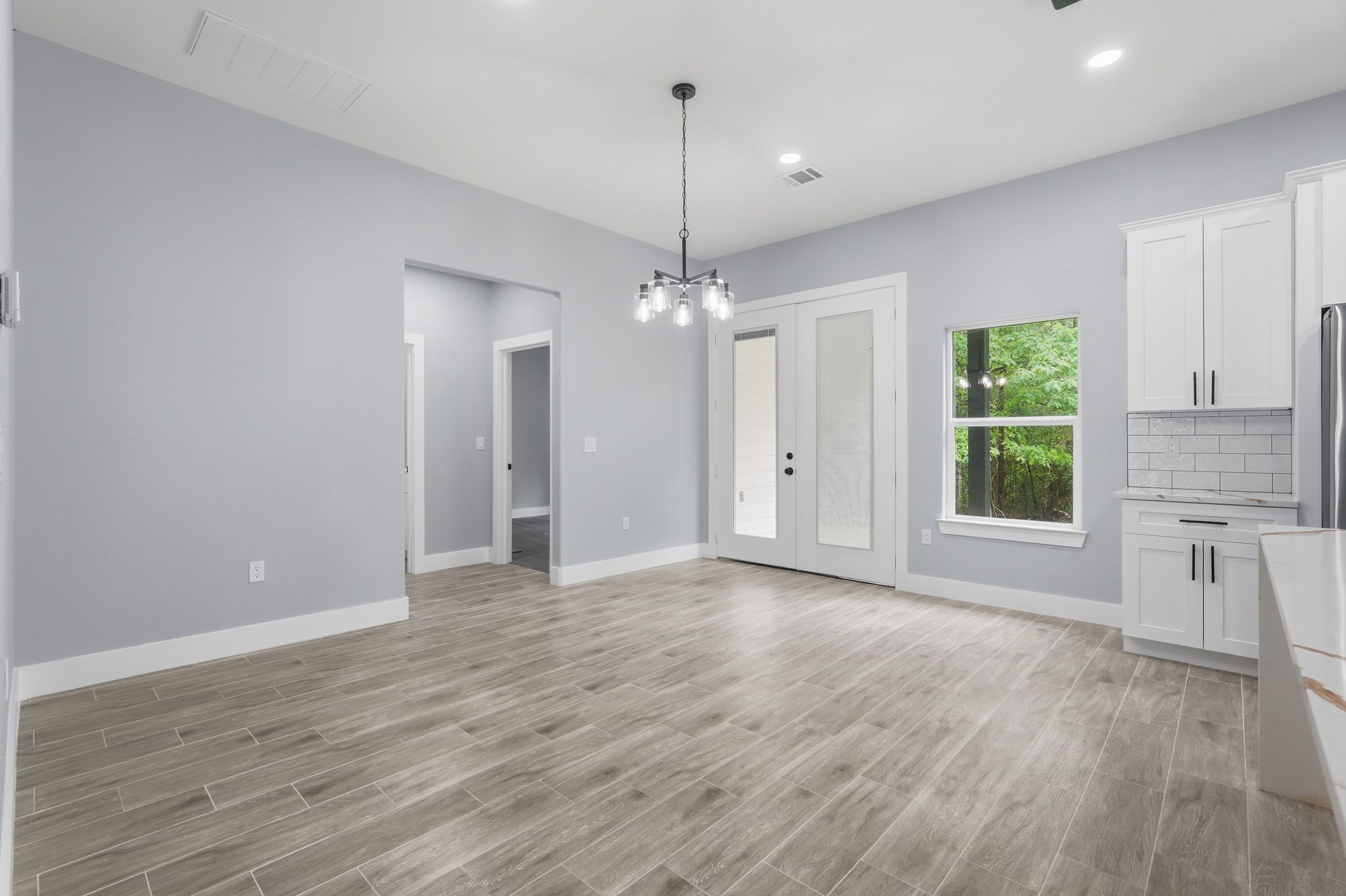 3575 Roy Bean Road Willis, TX 77378 - Photo 11 of 40 a view of a kitchen with a dishwasher cabinets and a floor to ceiling window