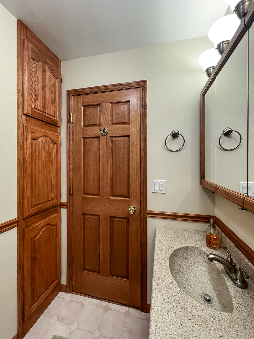 42W420 Kedeka Road Sugar Grove, IL 60554 - Photo 21 of 32 a bathroom with a sink and a mirror