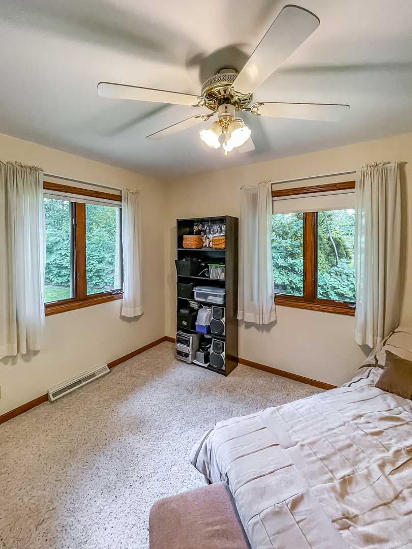 42W420 Kedeka Road Sugar Grove, IL 60554 - Photo 23 of 32 a bed sitting in a spacious bedroom next to a window