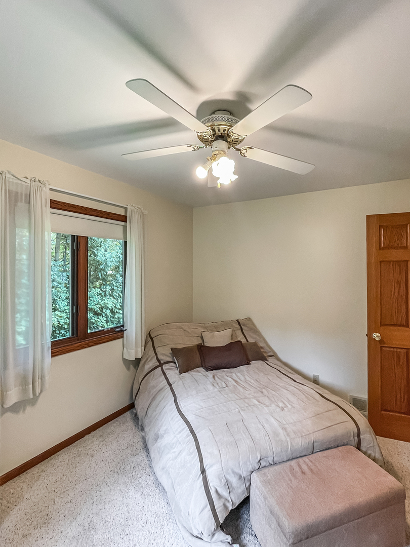 42W420 Kedeka Road Sugar Grove, IL 60554 - Photo 24 of 32 a bedroom with a bed and a large window