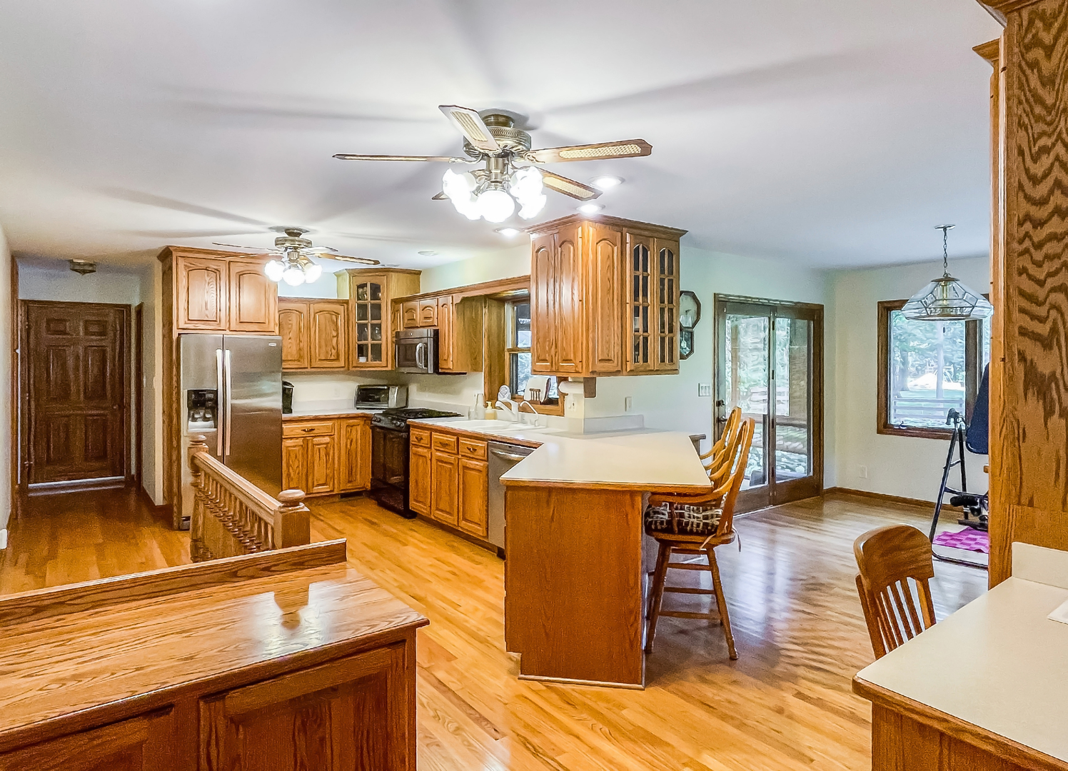 42W420 Kedeka Road Sugar Grove, IL 60554 - Photo 5 of 32 a kitchen with stainless steel appliances kitchen island granite countertop a table chairs sink and cabinets