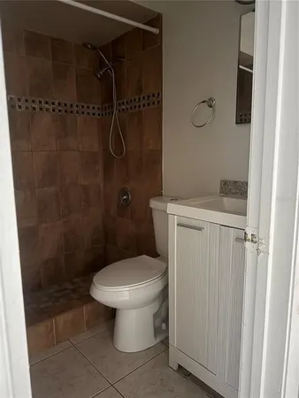 a white toilet sitting next to a bathroom sink