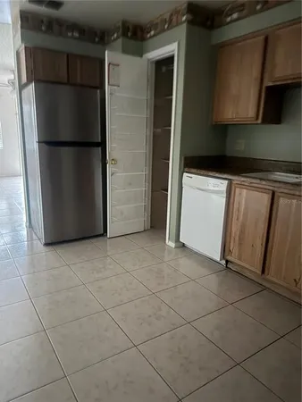 a kitchen with a refrigerator and a stove