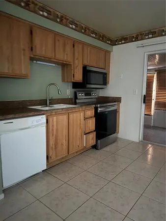 a kitchen with stainless steel appliances granite countertop a sink and a stove