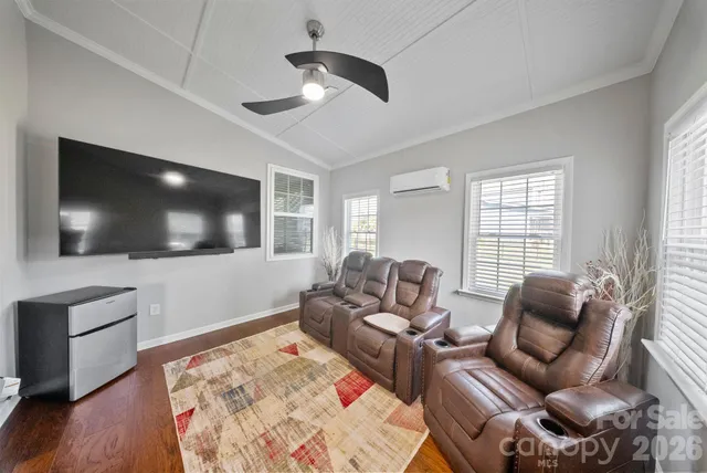 a bed room with furniture and a flat screen tv