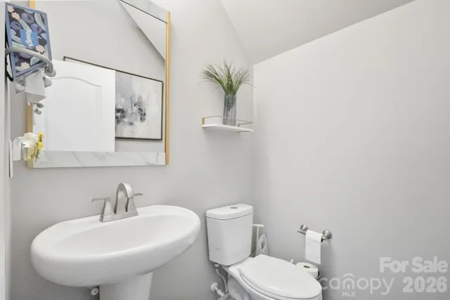 an aerial view of a residential houses with outdoor space and trees