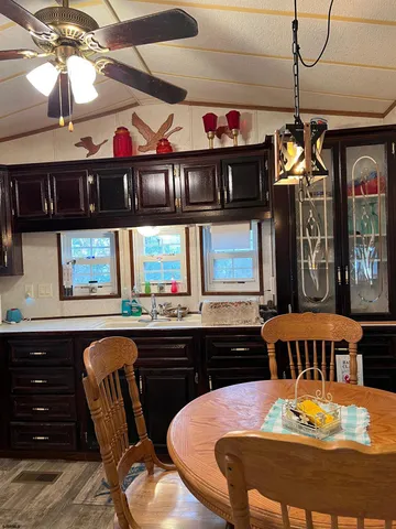 a view of a dining room with furniture and chandelier