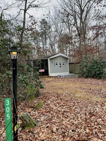 a sign board with yard in front of it