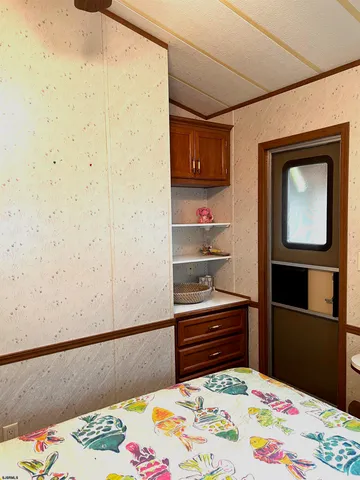 a bedroom with a bed and cabinets