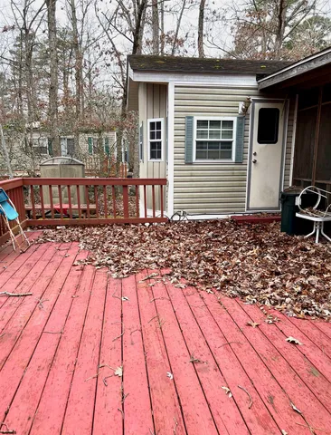 a view of a dinning table and chairs in patio of the house