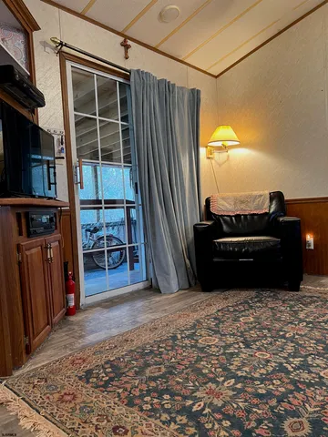 a living room with a couch and a dresser next to a window